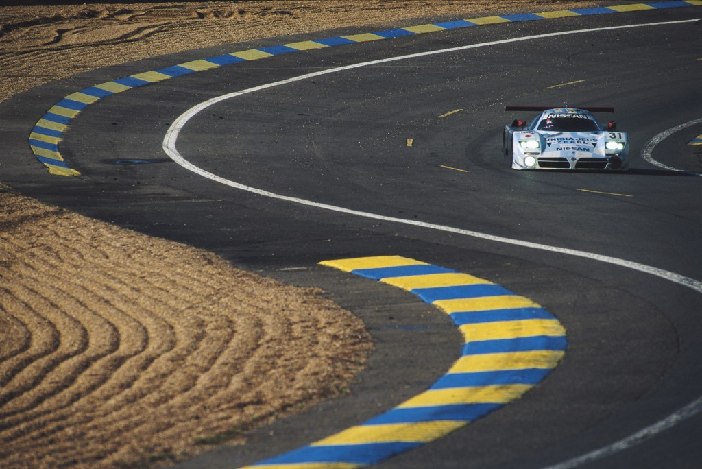 The Nissan R390 GT1 race car on a paved road