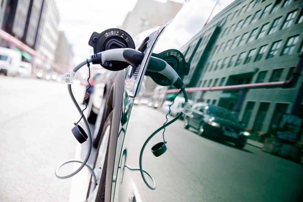 A plug-in hybrid car charges batteries at a station in the Berlin-Mitte district of the German capital.