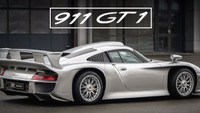 The rear 3/4 view of a silver Porsche 911 GT1