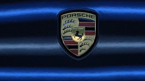 Classic Porsche logo against a black and blue background
