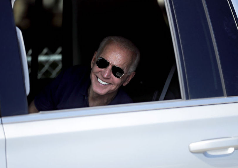President Biden smiling inside of truck