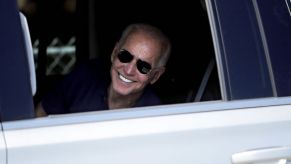 President Biden smiling inside of truck