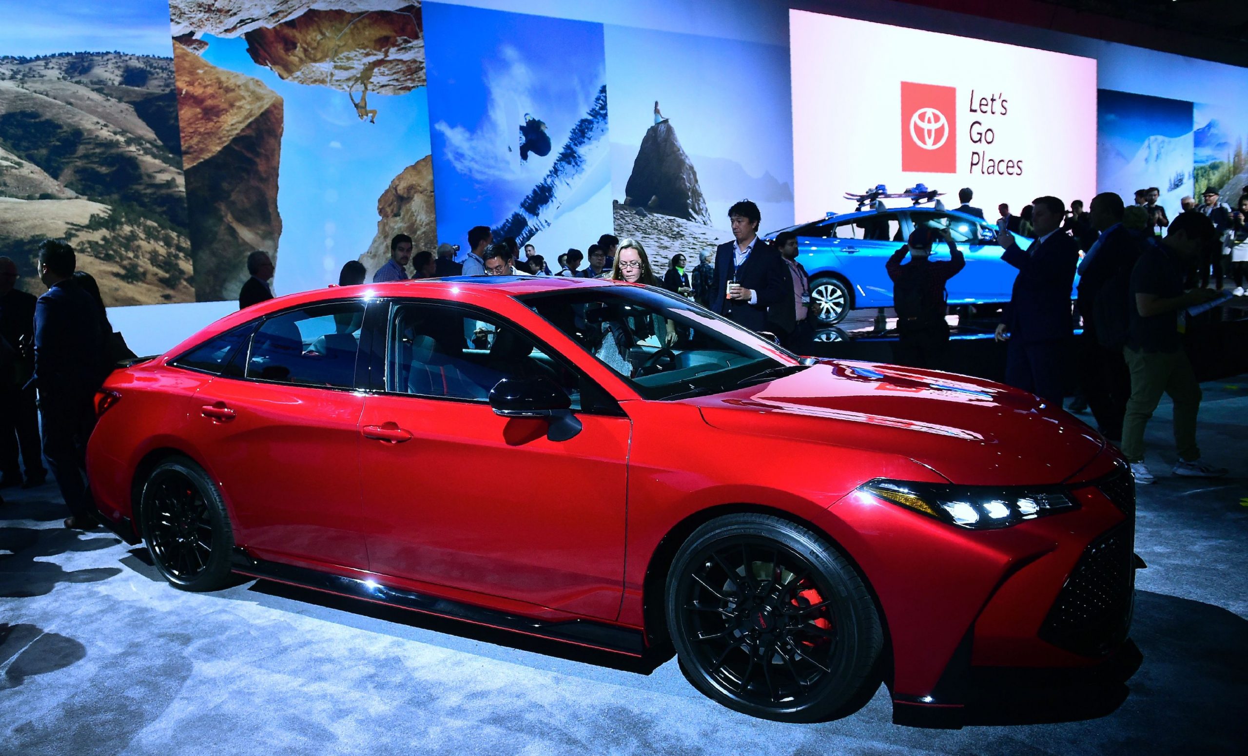 People take a closer look at the new red 2019 Toyota Avalon TRD on display