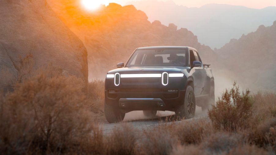 Rivian electric truck parked in a hazy desert