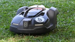 A robotic lawn mower mowing grass