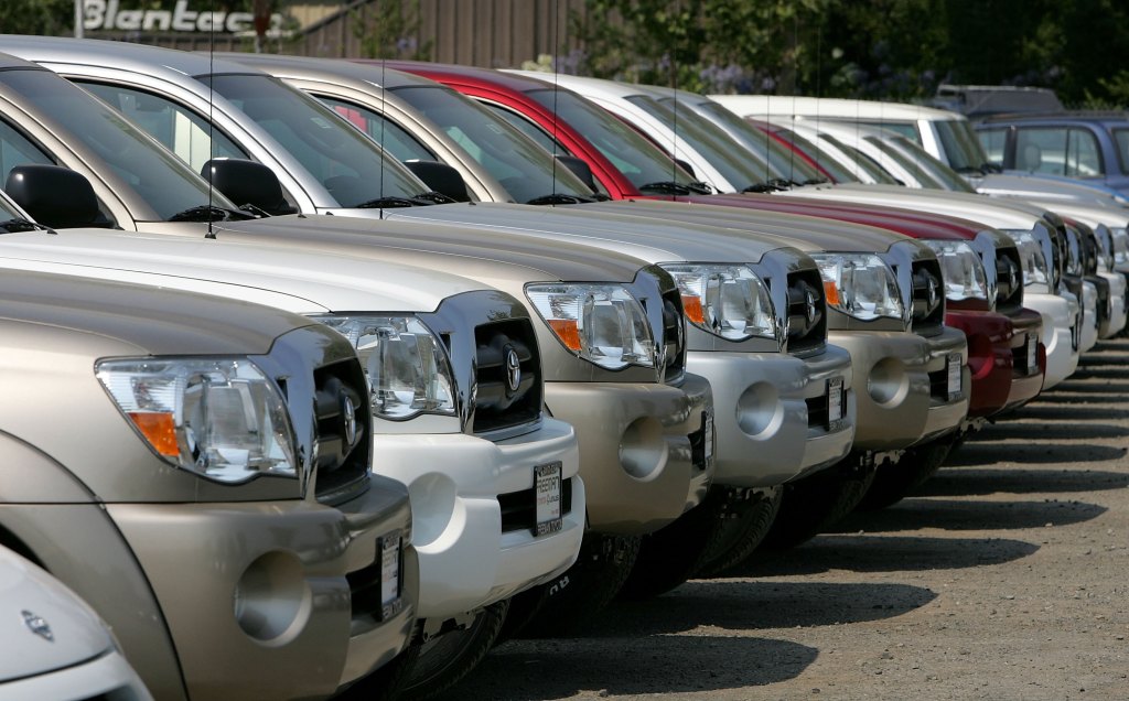 A row of pickup trucks on a dealership lot. Pickup trucks are safer than cars due to their weight and size.