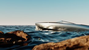 polished aluminum hull floating amongst the rocks