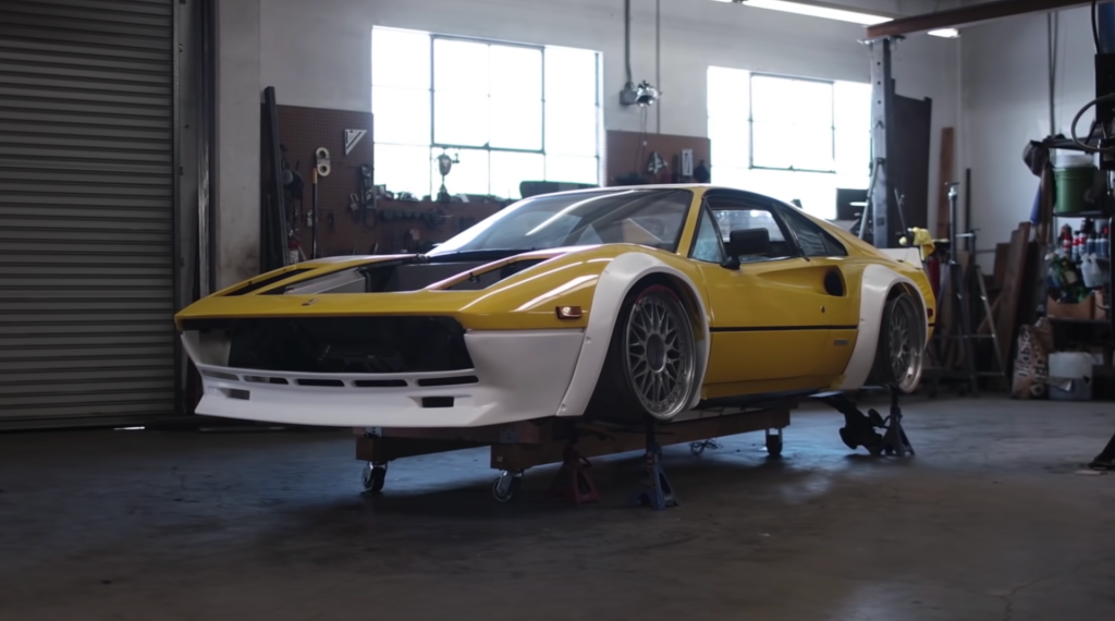 An image of a widebody Ferrari in a workshop.
