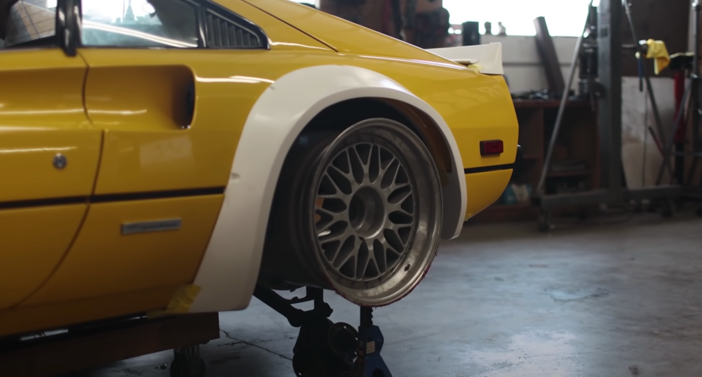 An image of a widebody Ferrari in a workshop.