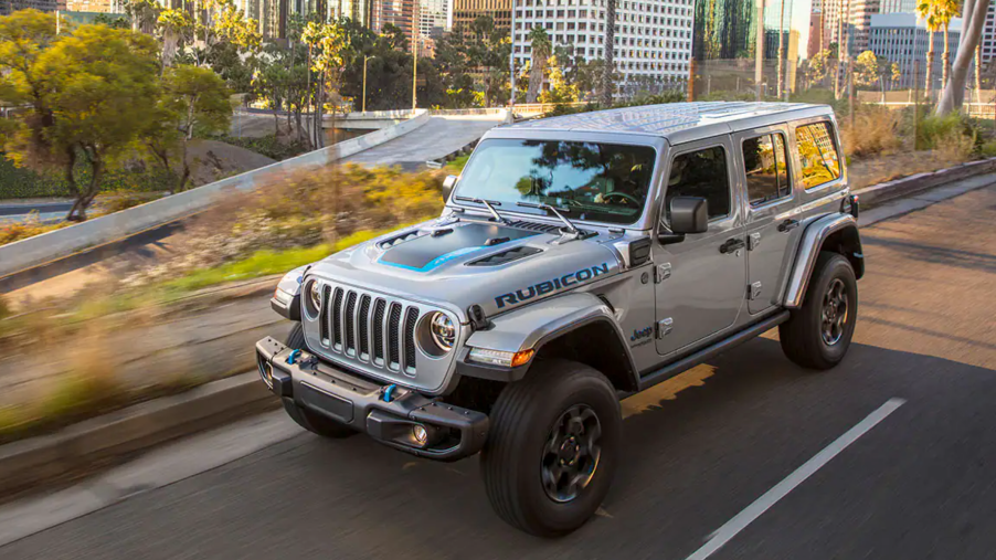 The 2021 Jeep Wrangler 4xe driving on a city street
