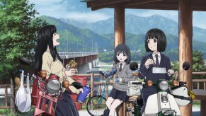 The three main heroines of the Super Cub anime with their bikes by a mountaintop rest area