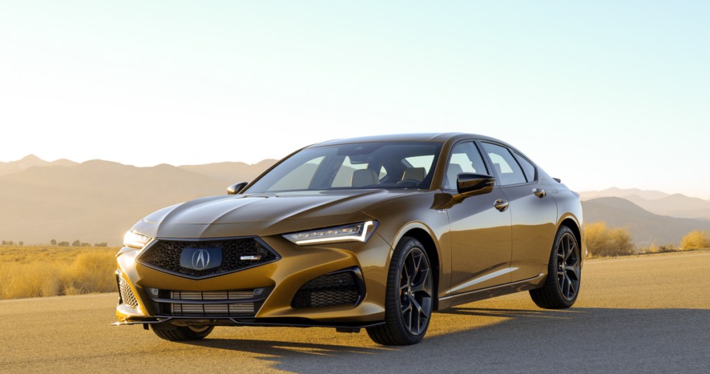 A gold Acura TLX Type S sits on tarmac at sunset
