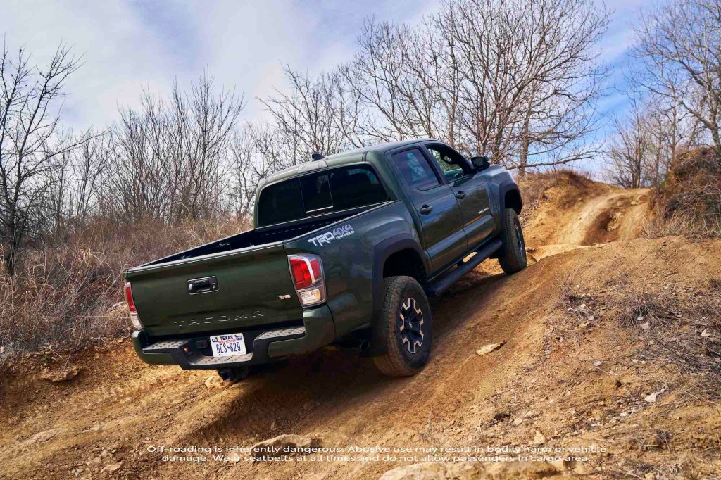 a rear shot of the 2021 Toyota Tacoma Off Road with TRD Lift Kit driving off road