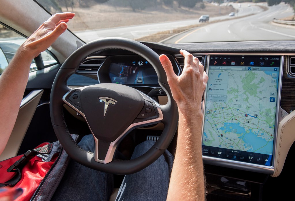 A driver goes hands free while using Tesla Autopilot. 
