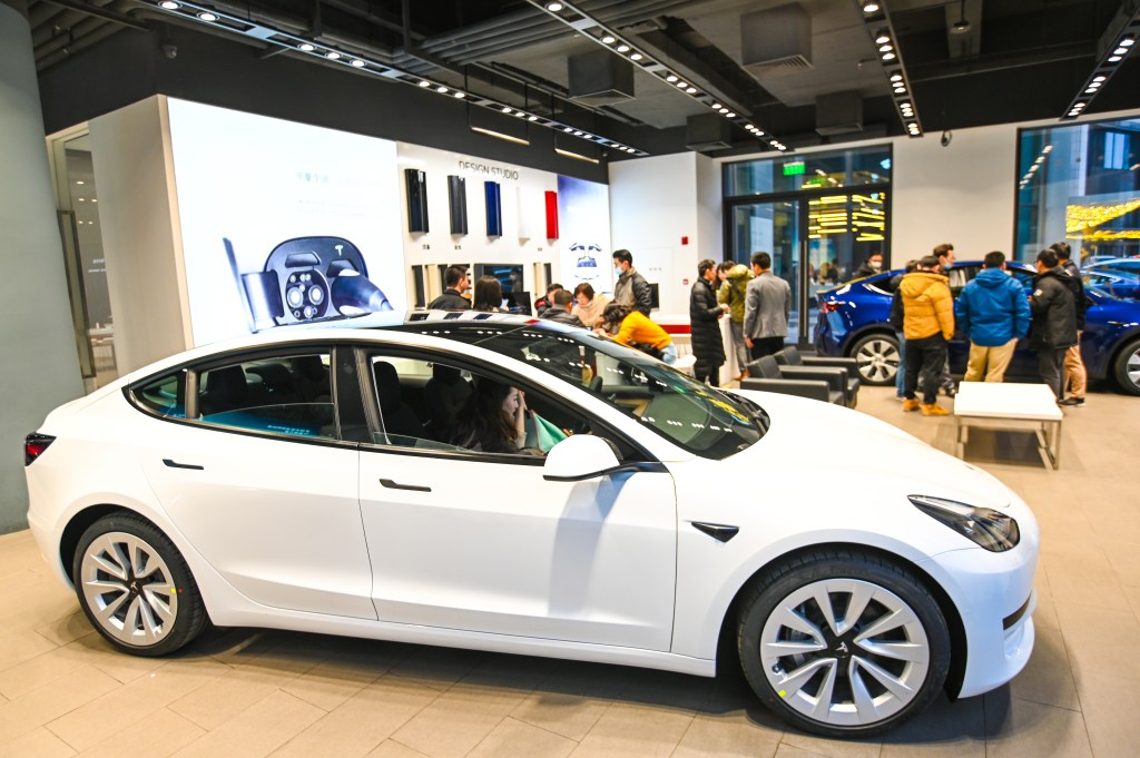 A white Tesla Model 3 vehicle is seen at a Tesla flagship store on January 4, 2021 in Shanghai, China