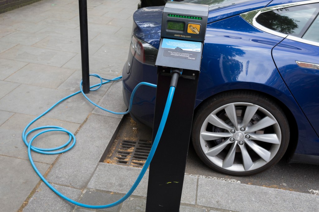 A blue Tesla Model S charging