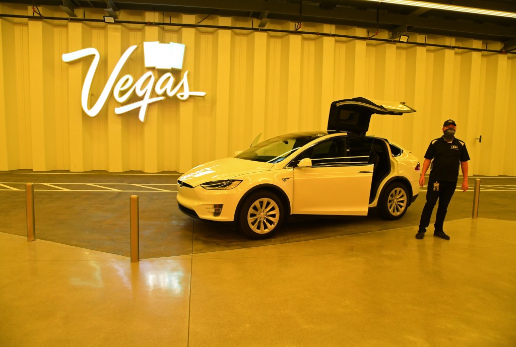 A white Tesla Model X is parked with the gull-wing doors up in the Central Station during a media preview of the Las Vegas Convention Center Loop