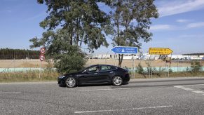 A Tesla Model S EV sedan on a highway