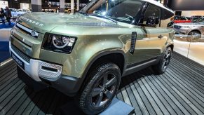 Green Land Rover Defender 90 off-road 4x4 vehicle on display at Brussels Expo