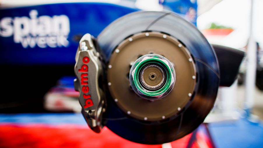 The green wheel nut and Brembo brake disc on a blue Formula GP3 car