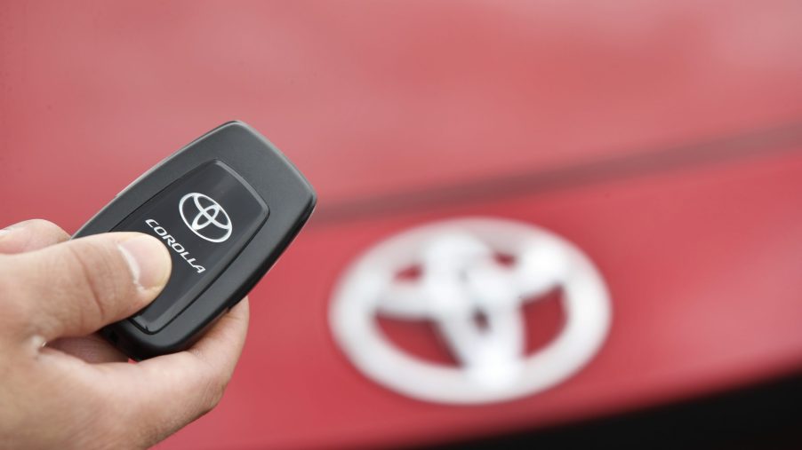 A salesman holds the key fob of a red Toyota Motor Corp. Corolla vehicle at the Brent Brown Toyota dealership. The key fob has control over the car alarm