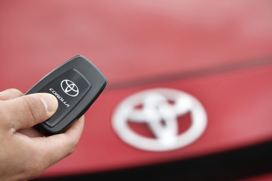 A salesman holds the key fob of a red Toyota Motor Corp. Corolla vehicle at the Brent Brown Toyota dealership. The key fob has control over the car alarm
