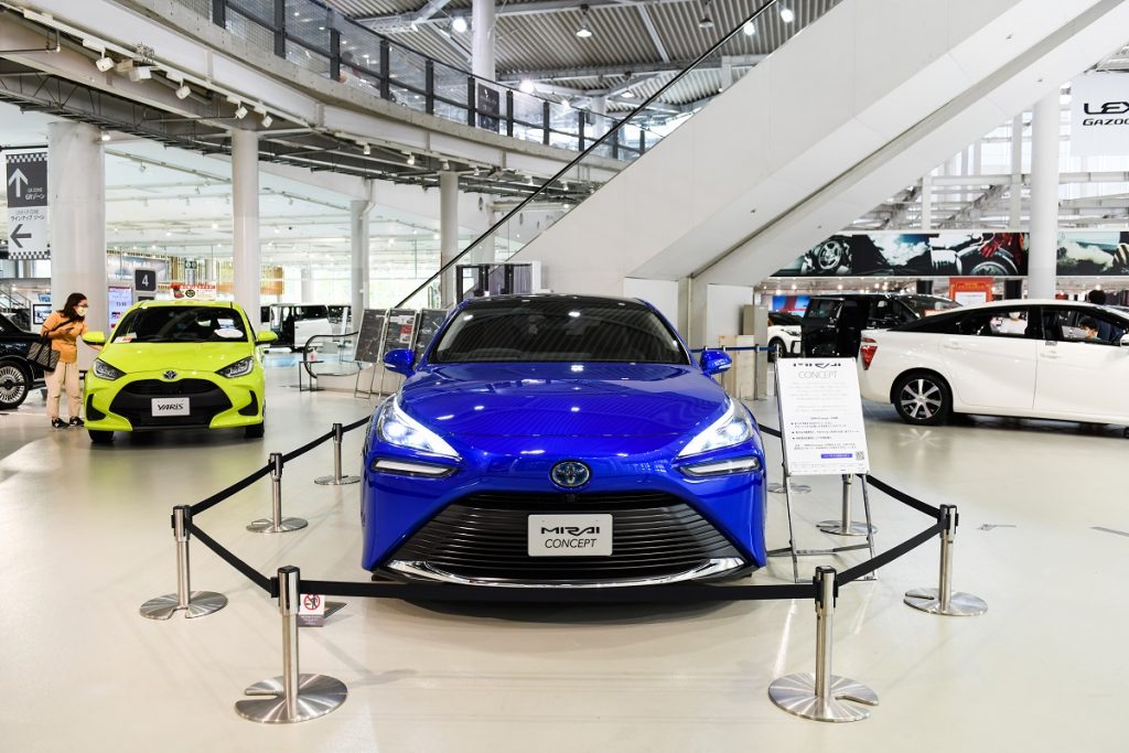 A blue 2021 Toyota Mirai on a showroom floor.