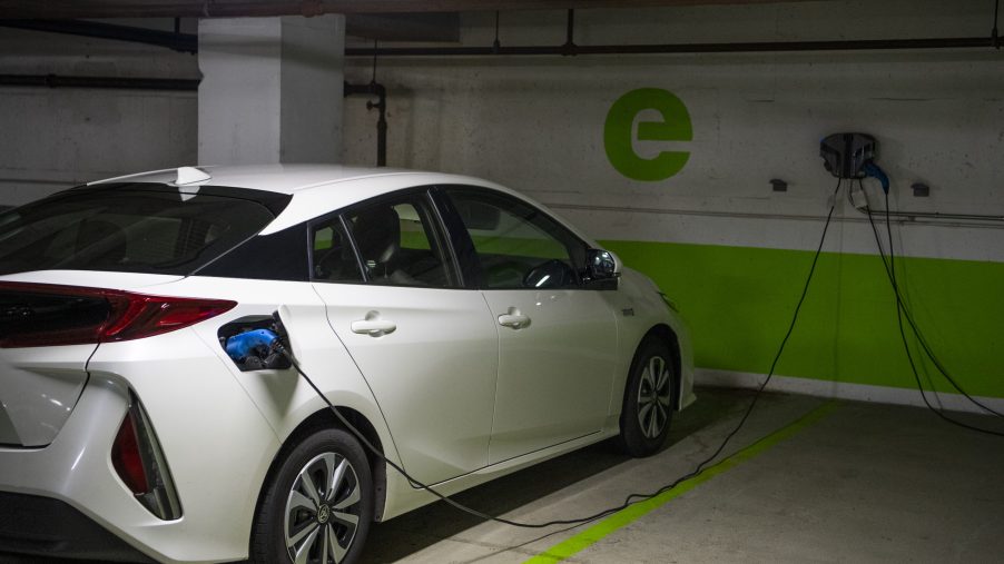 A white Toyota Prius is seen connected to a electric vehicle charging station in a Washington, D.C., parking garage