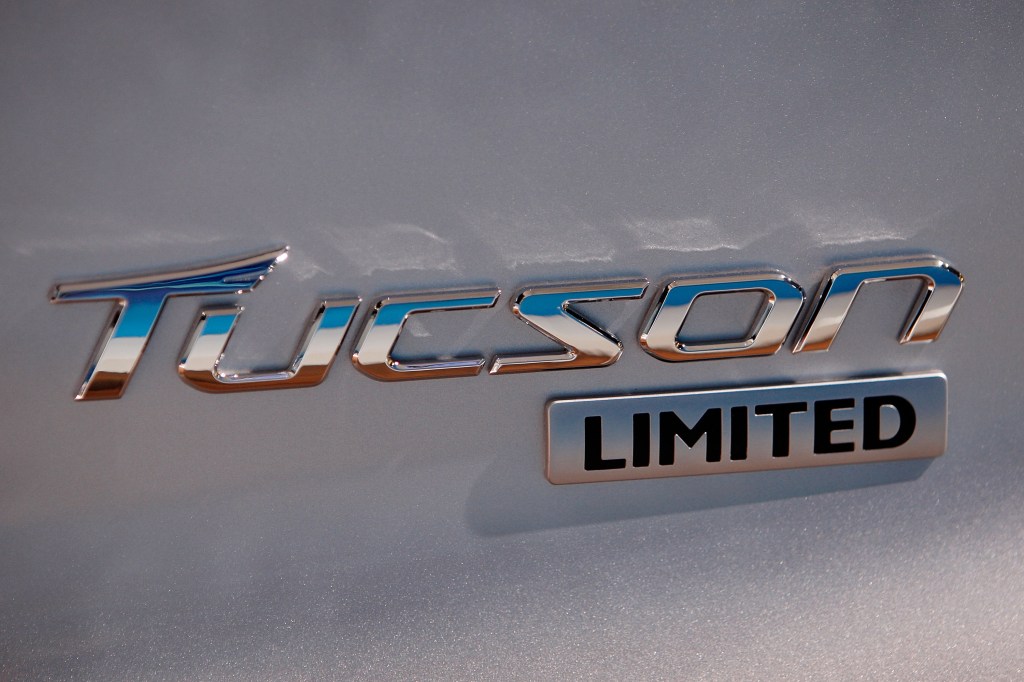 A chrome Hyundai Tucson badge on a silver SUV