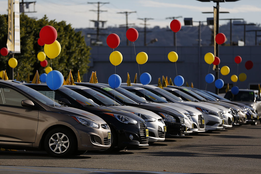 used car dealer with colorful ballons