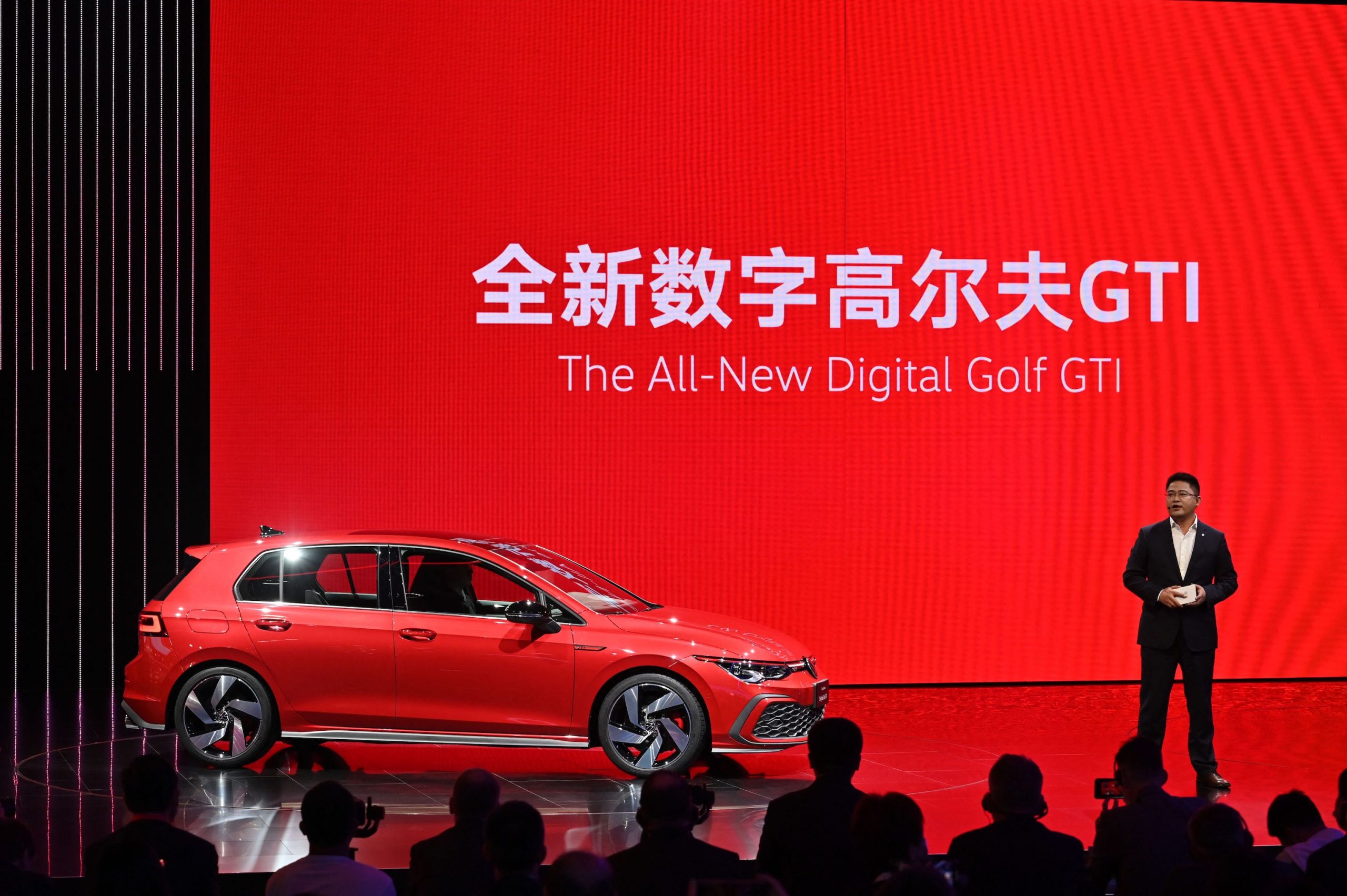 Guo Yongfeng, President of Faw-Volkswagen Sales, presents the new red Volkswagen Golf GTI car during the 19th Shanghai International Automobile Industry Exhibition in Shanghai