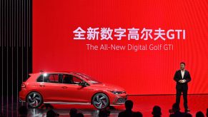 Guo Yongfeng, President of Faw-Volkswagen Sales, presents the new red Volkswagen Golf GTI car during the 19th Shanghai International Automobile Industry Exhibition in Shanghai