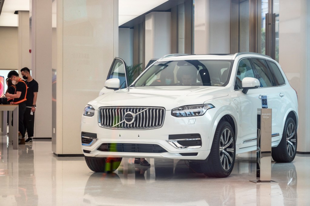 One of the safest midsize luxury SUVs, a Volvo XC90 on a display showroom floor.