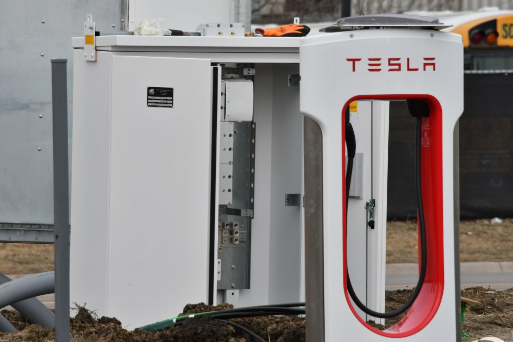Electrical contractors work on installing the wiring on Tesla supercharger stations