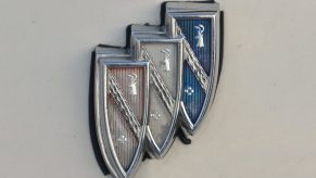 A faded red, white, and blue Buick logo emblem