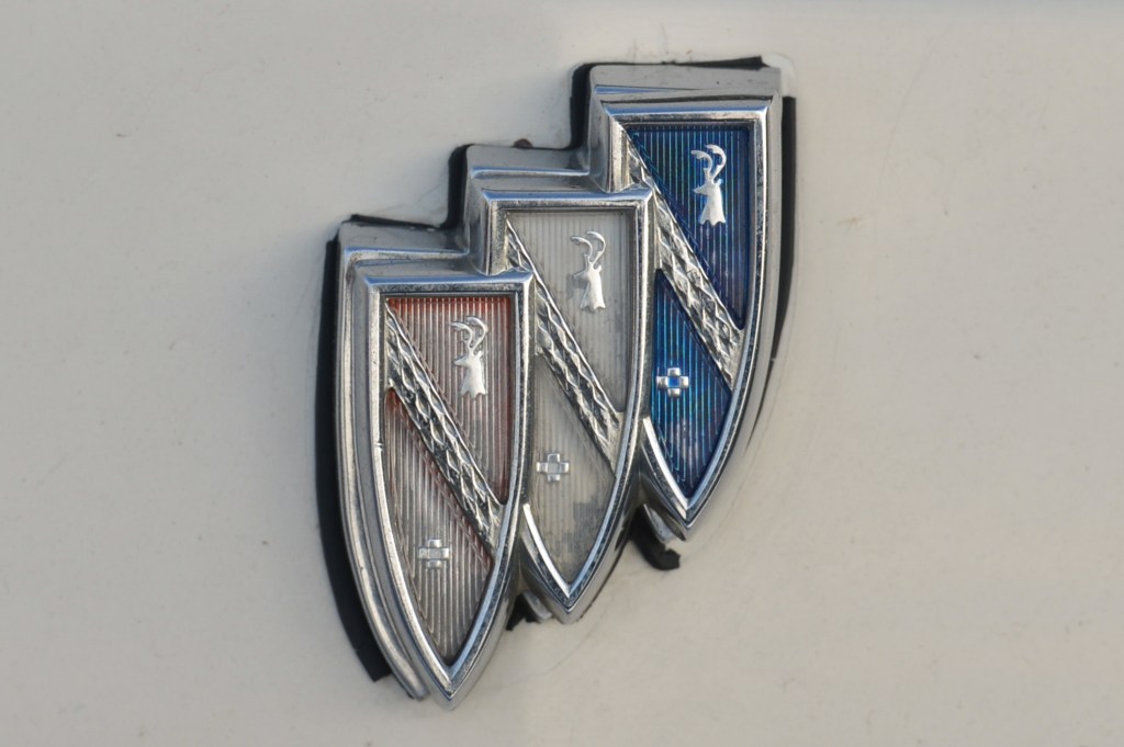 A faded red, white, and blue Buick logo emblem