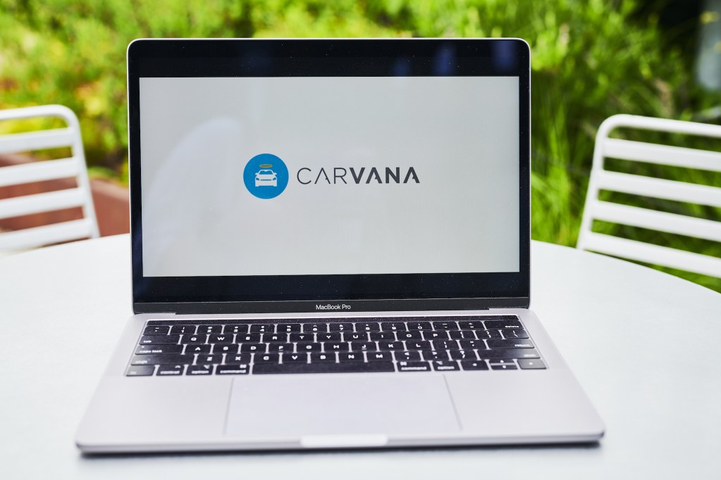 The logo for Carvana Co. is displayed on a laptop computer. 