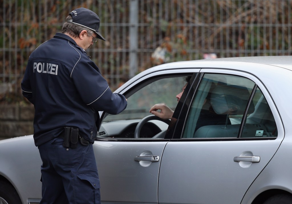  A policeman pulls over a car caught for speeding during a city-wide police action to catch people for speeding and other traffic infringements. 