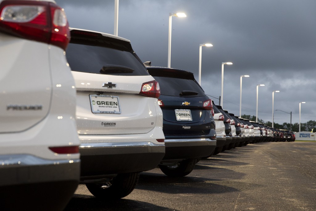 A line of cars at a car dealership.