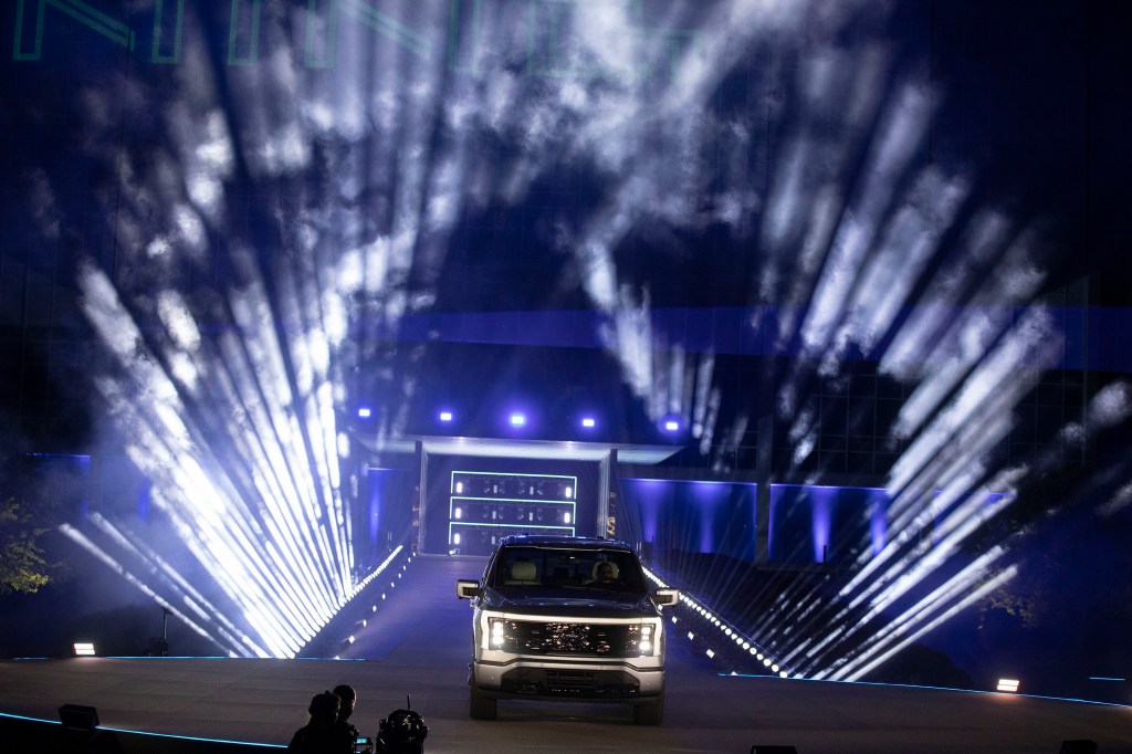 The Ford F-150 debuts amidst flashing lights.