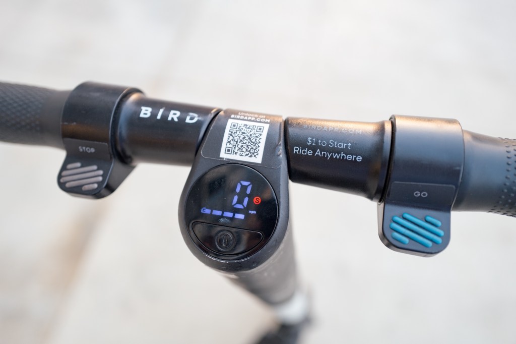 Close-up of handlebars and electronic data dashboard on a motor scooter. 