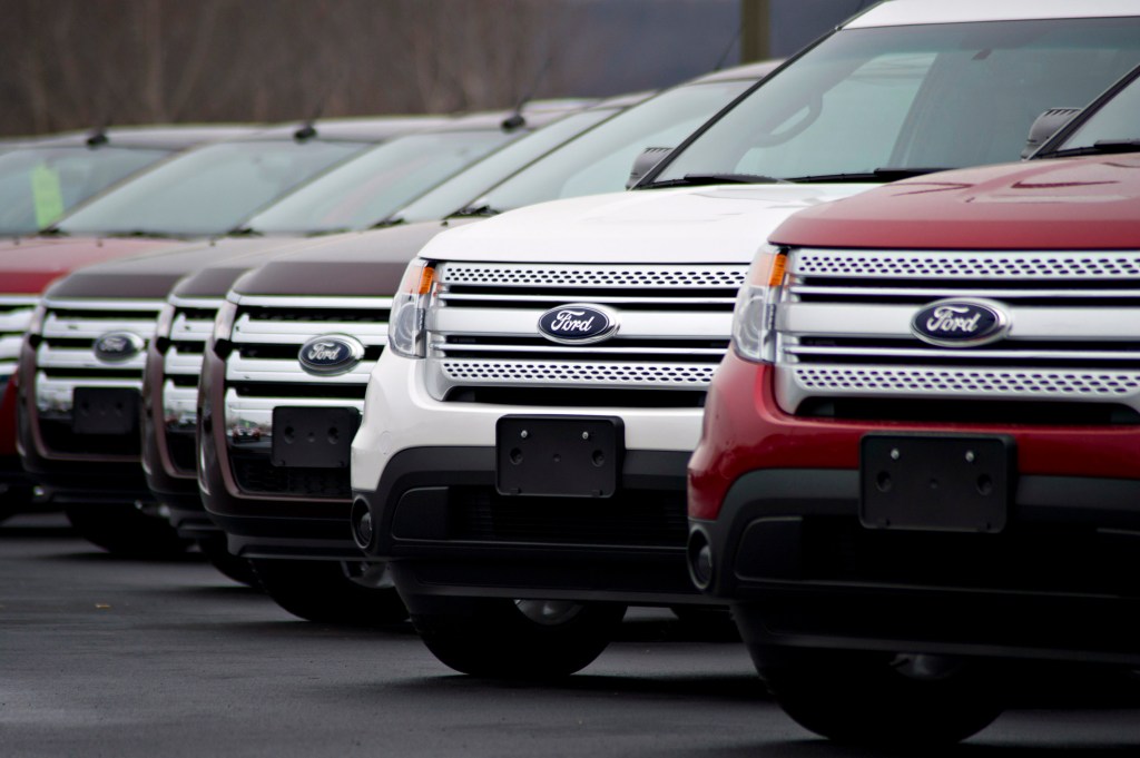 A line of multi-colored Ford Explorers in a parking lot