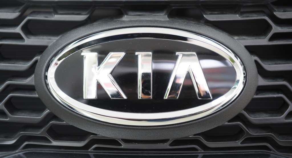 A kia badge on the front grille of a kia forte