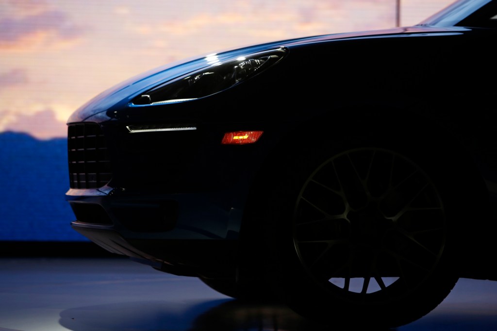 A shadowy photograph of the nose of the Porsche Macan , highlighting the body lines of the car.