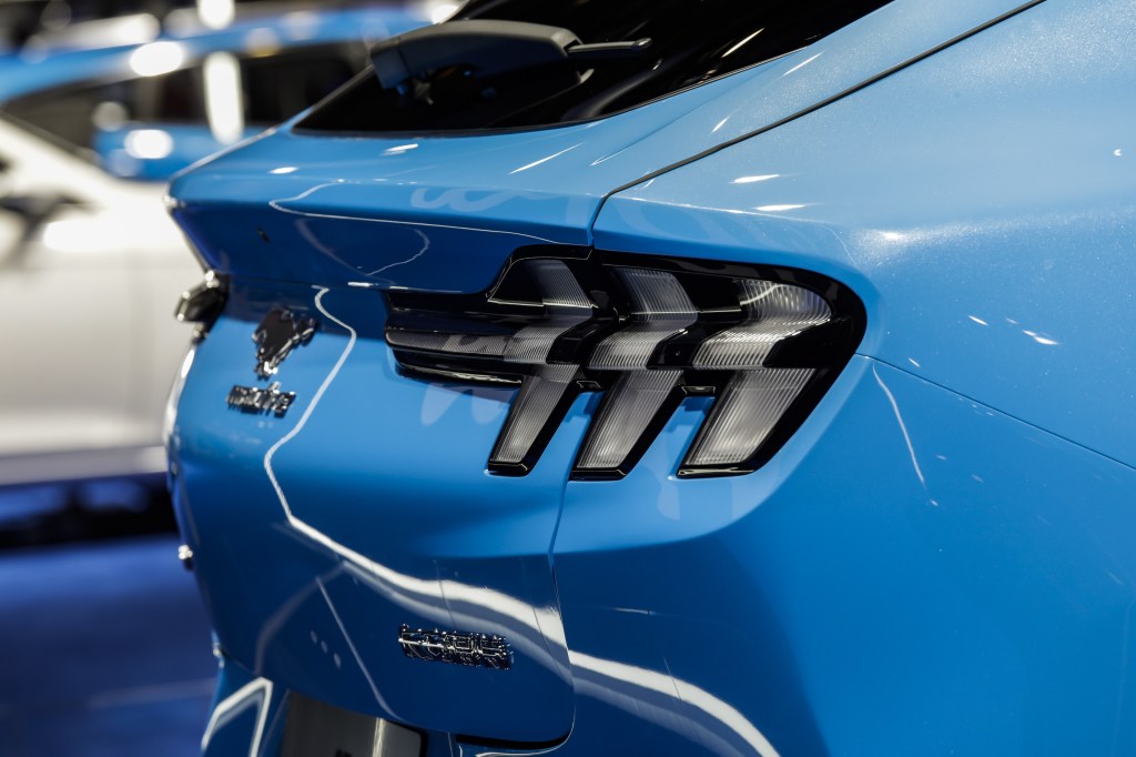 A close up of the rear end of a blue Mustang Mach-E