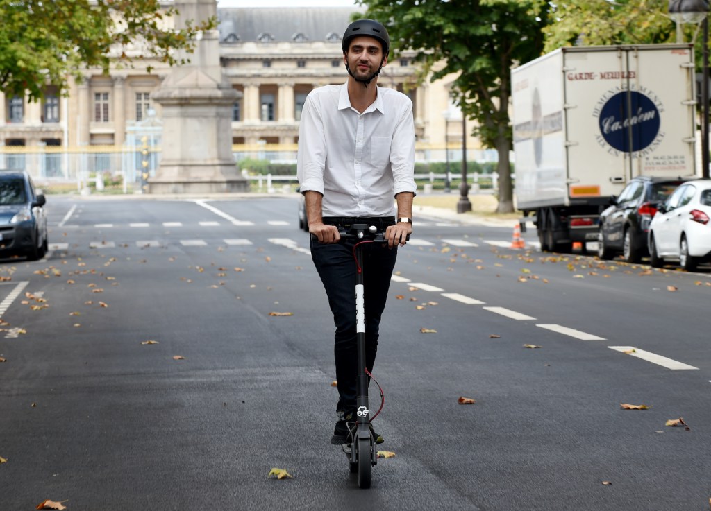 A man drives on an electric scooter in Paris. 