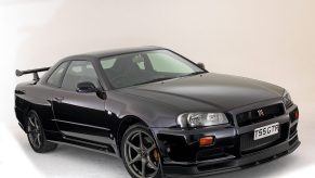 An image of a Nissan Skyline GT-R parked in a photo studio.