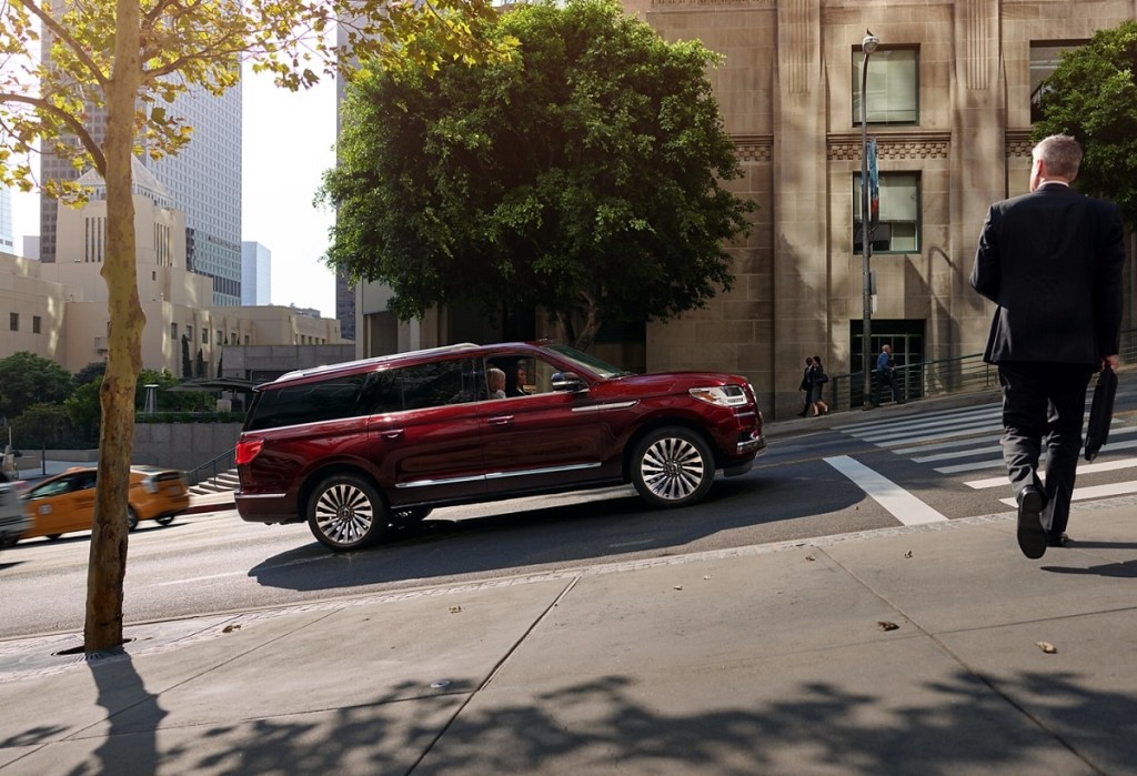 A 2021 Lincoln Navigator driving through a city.
