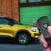 A hand remote starts a Kia Seltos