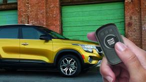 A hand remote starts a Kia Seltos
